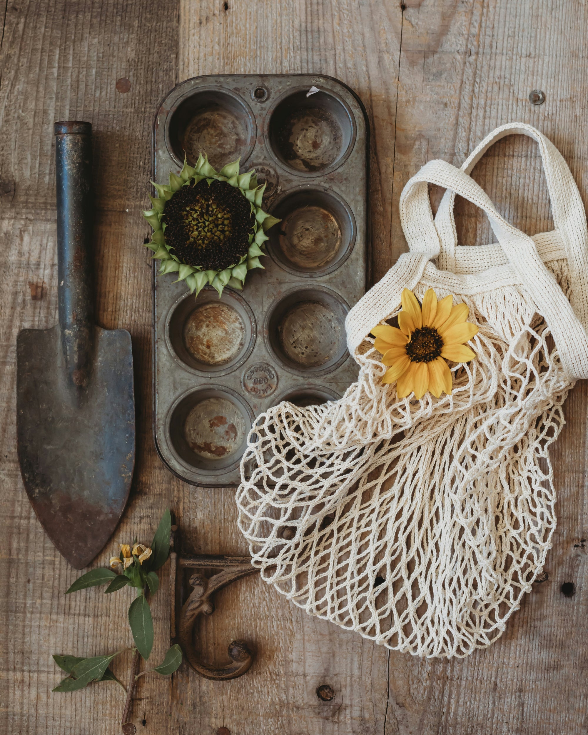 Welcome to Henflower - image of repurposed garden supplies, sunflower, and a reusable shopping bag.